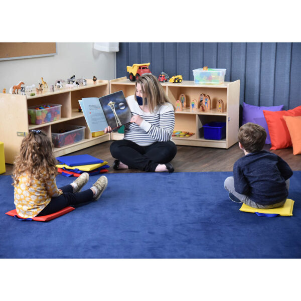 Teacher Reading to Kids on Mats